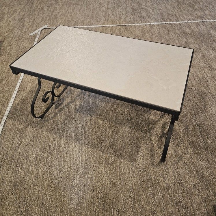 Ceramic top wrought iron Shelf with a scrolling Foldable base.
