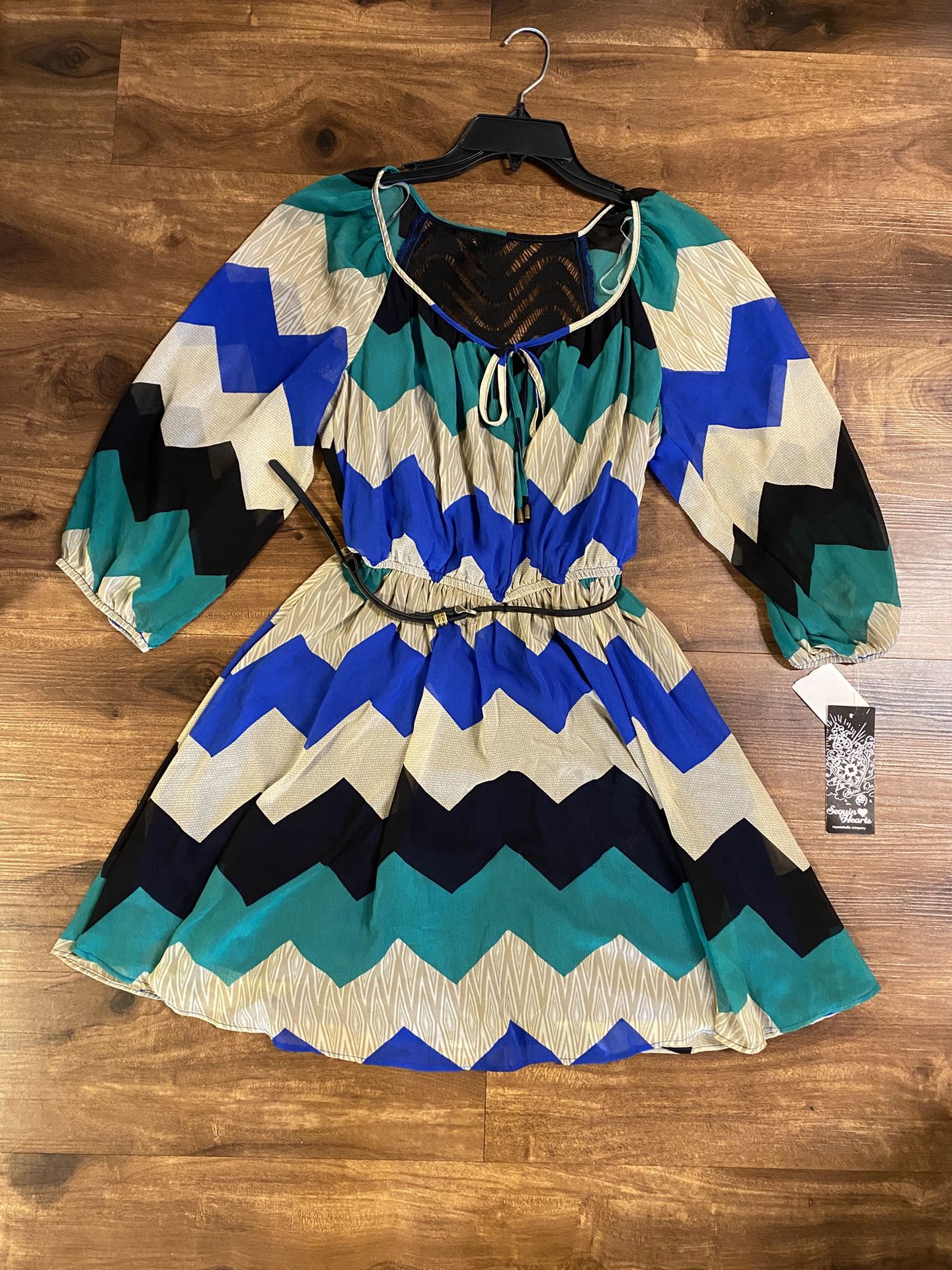Brand new Woman’s Sequin Hearts brand blue, teal, black, and white colored zig zag dress up for sale