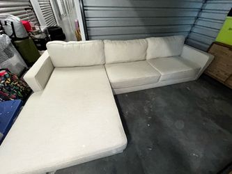 Cream fabric sectional sofa with left facing chaise