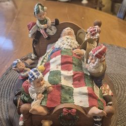 Vintage resin santa claus in bed with elves