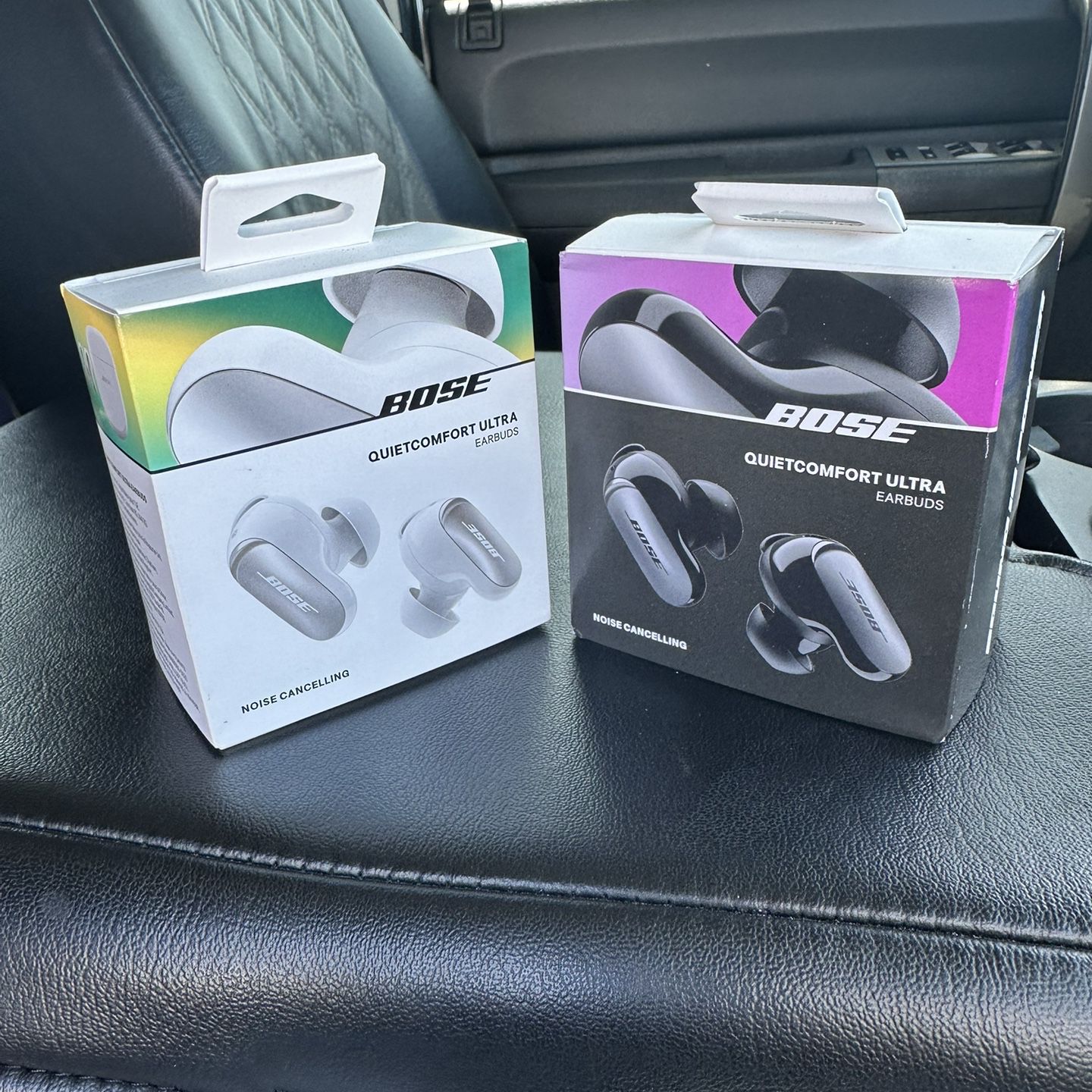 Bose Quietcomfort Ultra Earbuds. One Is White The Other One Is Black