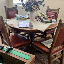 Solid Oak Pedestal Table and four solid oak chairs also two leafs
