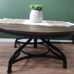 Round industrial rustic adjustable wood coffee table. 