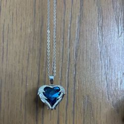 Blue heart necklace with angel wings surrounding the heart