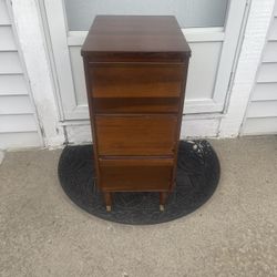 Wooden bedside table with three shelves