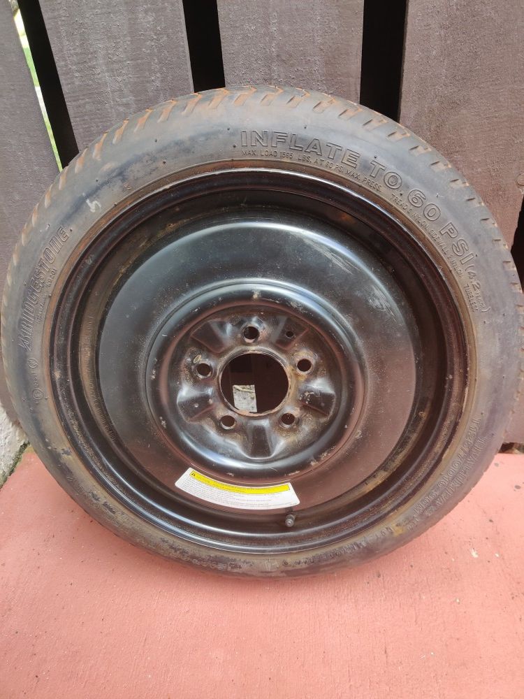 Standard Nissan spare tire with rim