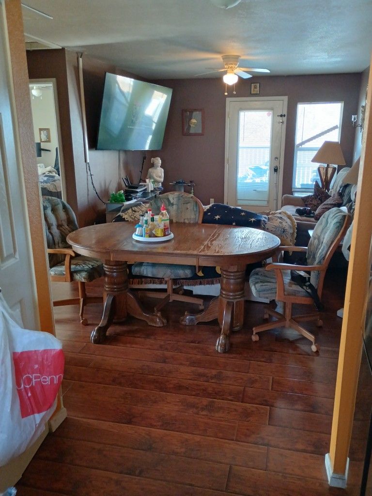 Solid Wood Table With Lion Arm Base And Rolling Arm Chairs