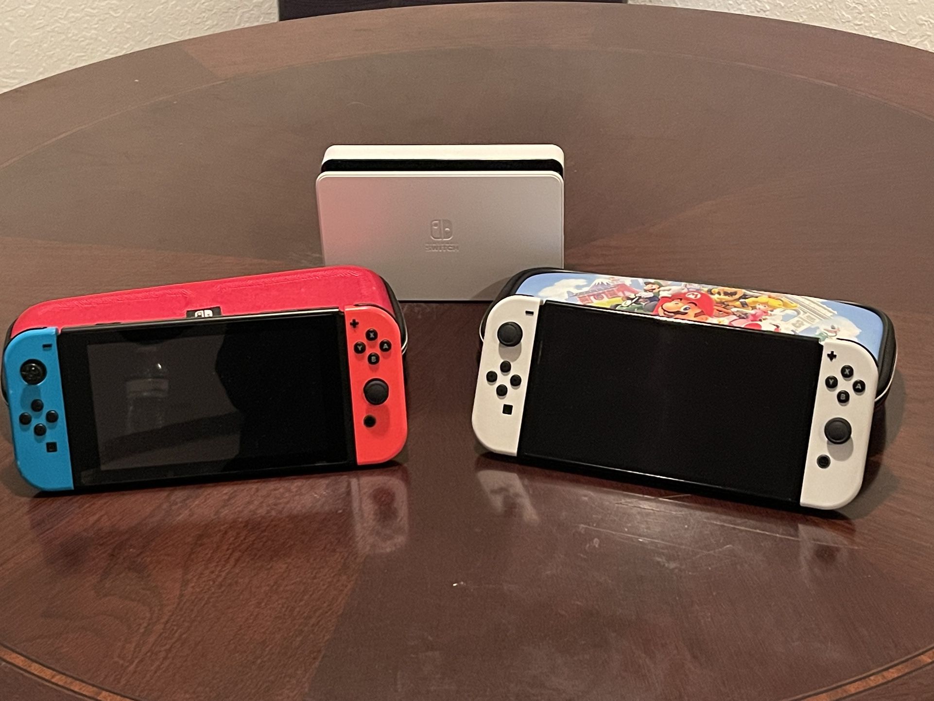 Two Nintendo switches, Charging Station With Cases And 5 Games $350