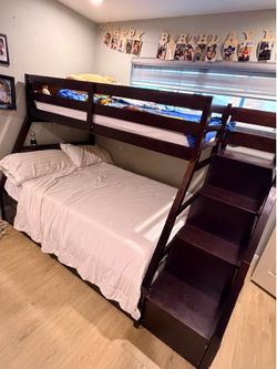 Dark wood bunk bed with trundle and storage stairs. Come with barely used twin size mattress.