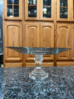 Vintage Glass Round cake plate on a clear pedestal.  Size 10 1/ 2 inches wide and 5 inches tall.  Preowned.  Has been on display in a cabinet.