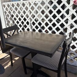 Drop leaf wooden table and two chairs. Good condition, not new but great for small spaces
