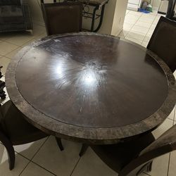 Round wood table with four chairs