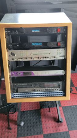 Recording studio rack with wheels and gear thats in the pick.