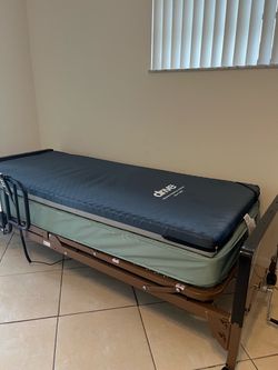 Drive semi-electric hospital bed and mattress with gel overlay.