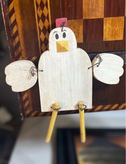 This vintage wooden chicken decoration features a charming, handcrafted folk art design with movable wire wings and legs.....  • The body is made of l