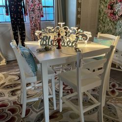 White high top table with four chairs