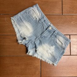 These blue jean shorts by Almost Famous feature a distressed design with frayed hems and a faded wash, offering a trendy and casual look. The raw edge