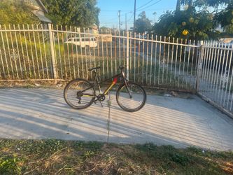 Pedal bike 24 inch the color is black, yellow, and red