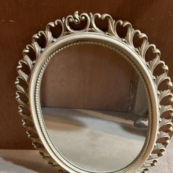 Antique mirror, 24 inches tall 18 inches wide in a bone white paint on wood construction