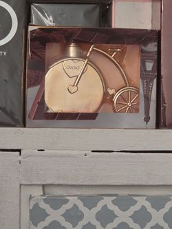 I have band new deold gold bicycle shaped decorativeolla item perfume for sale band new