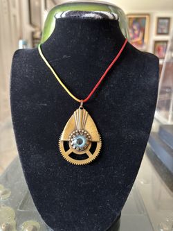 Glass eye over brass antique collectable items hand crafted and signed by American glass artist G. Fone with adjustable colorful cloth string. 2” x 1.