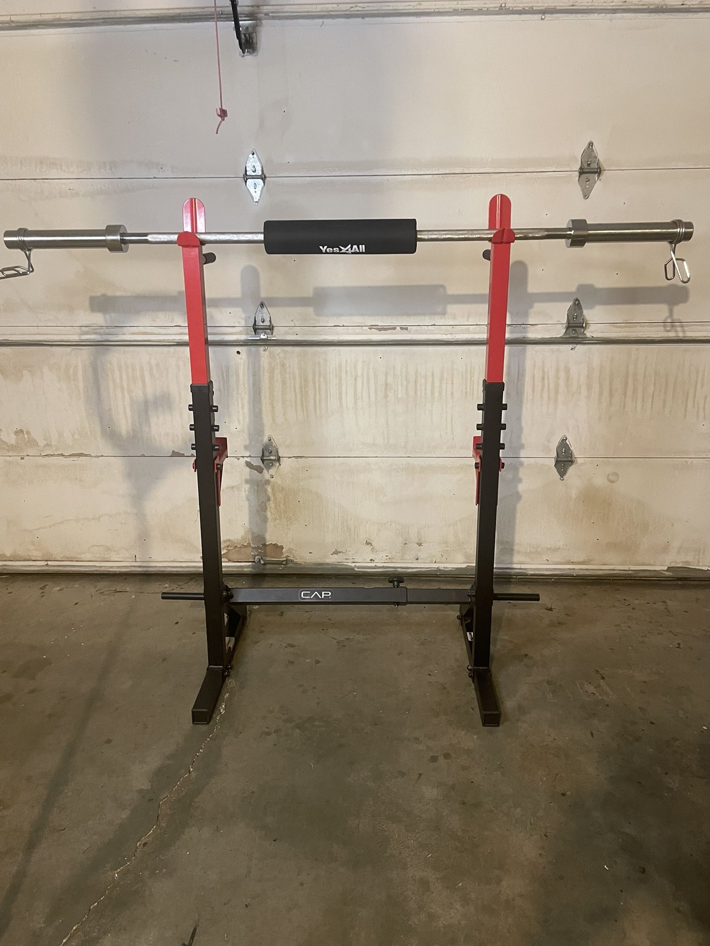 CAP squat rack & 30lb, 6 foot olympic barbell with pad & clamps.