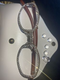 One (1) Millionaire Celebrity Italian Unisex wooden frame with sparkling lab, diamond ice trim. Comes with a white protective case for secure storage.