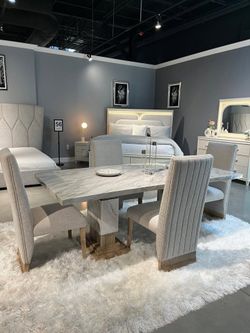 Stunning marble look dining set features sleek natural wood tone