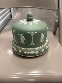 This is a Wedgwood Jasperware cheese dish, likely dating from the Victorian era around the 1870s, known for its iconic sage green ground and white