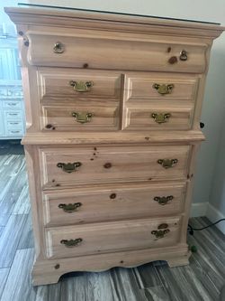 Tall bone color dresser with deep drawers.