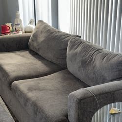 Light Gray Sofa and swiveling Love Seat