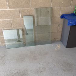 Glass. 2 sheets: 18.5”x17”x3/8”. $95x2=$190.  2 sheets: 35.5”x15”x1/8”. $80x2=$160.  4 sheets: 29.75”x8.25”x1/8”. $60x4=$240. I have the fifth sheet w