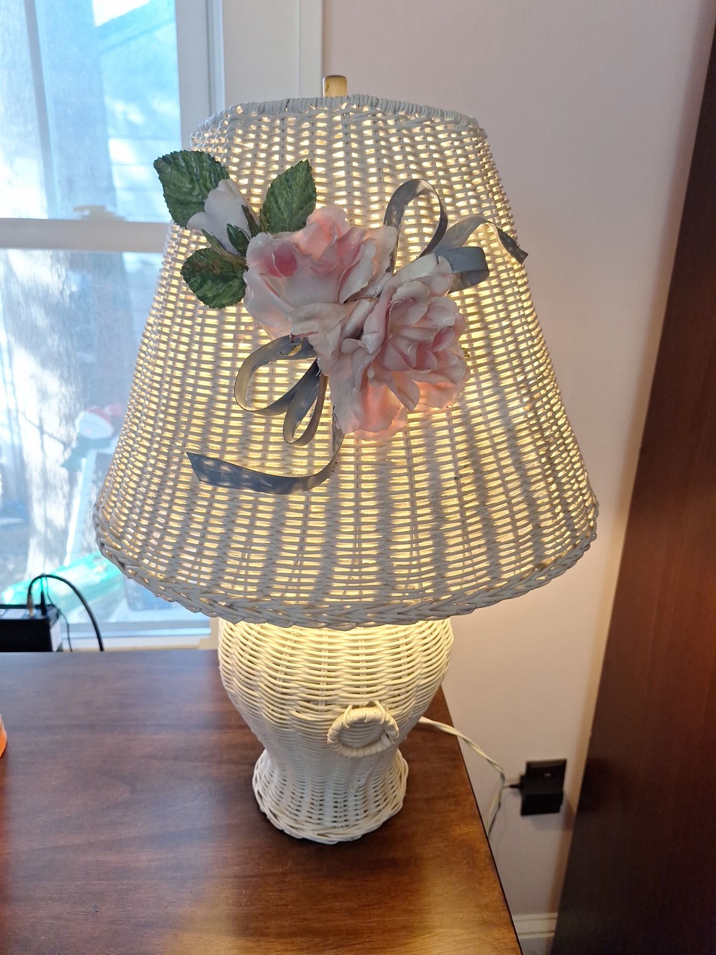 White wicker table lamp with fabric flowers and ribbons