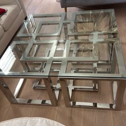 Stylish stainless steel coffee table with a glass tabletop.
