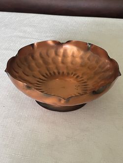 A vintage hand-hammered copper bowl with ruffled petal edges by Gregorian.