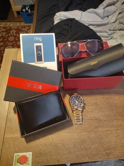 Cartier aviator men's sunglasses, Micheal Kors golden watch, Tumi black leather wallet, Ring Pro 2