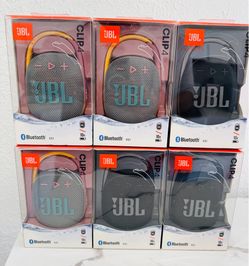 New JBL Clip 4 portable Bluetooth speakers. Bluetooth v5.1, 10H battery life, waterproof. Available in grey with teal logo, grey with pink logo, and b