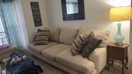 8-foot tan corduroy couch with four pillows.