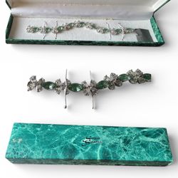 emerald and diamond bracelet featuring pear-shaped green emeralds surrounded by marquise-cut diamond