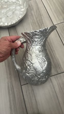 This is an Arthur Court cast aluminum pitcher featuring a rabbit motif.