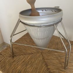 vintage aluminum cone sieve with a stand and wooden pestle