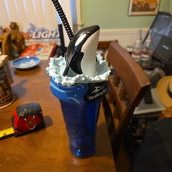 SeaWorld souvenir collectible park cup featuring an orca (killer whale) topper