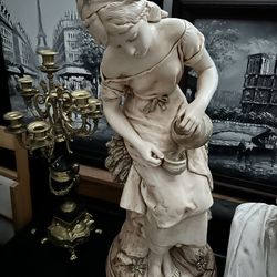 Sculpture Of Woman Gathering Water