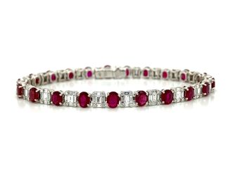 Ruby and Diamond Tennis Bracelet in 18K White Gold This bracelet is 18k white gold set with oval red rubies that have a combined total weight of 8.27 