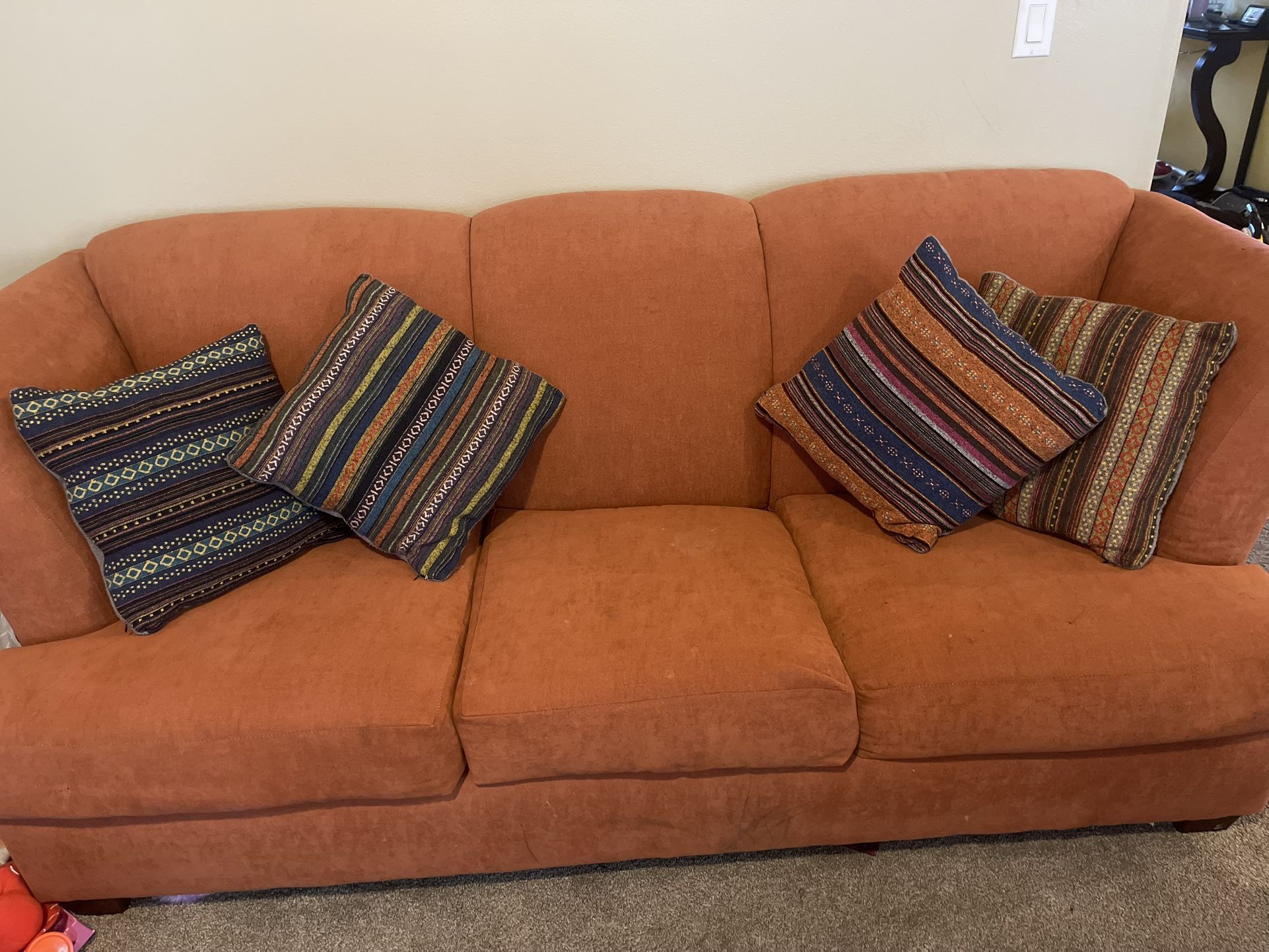 Orange Couch With Boho Pillows $100