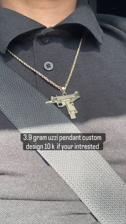 Gold uzzi pendant