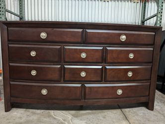 Dark Wood Curved Front Nine-Drawer Dresser