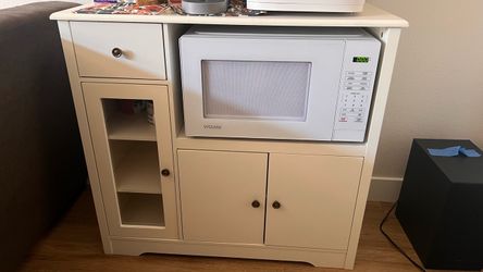 Storage Cabinet holds Microwave