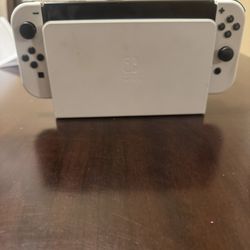 Nintendo switch OLED with two extra controllers, a switch case