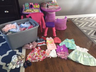 Storage bin of gently used 0-6 months clothing, shoes, boppy, car seat cover.